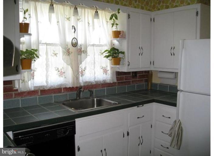 9117 Smith Avenue Nottingham, MD 21236 - Photo 15 of 17 a kitchen with granite countertop a sink and a stove