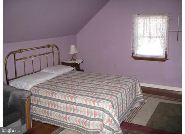 9117 Smith Avenue Nottingham, MD 21236 - Photo 4 of 17 a bedroom with a bed and window