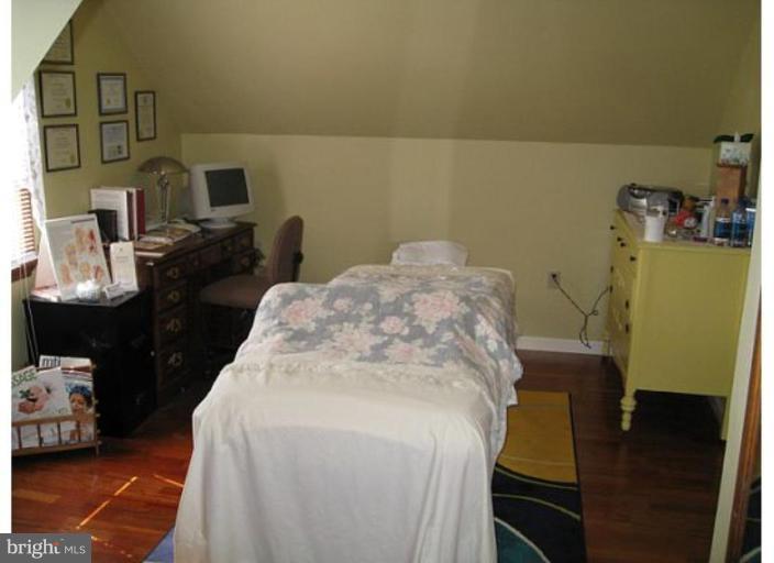 9117 Smith Avenue Nottingham, MD 21236 - Photo 6 of 17 a bed sitting in a bedroom next to a window