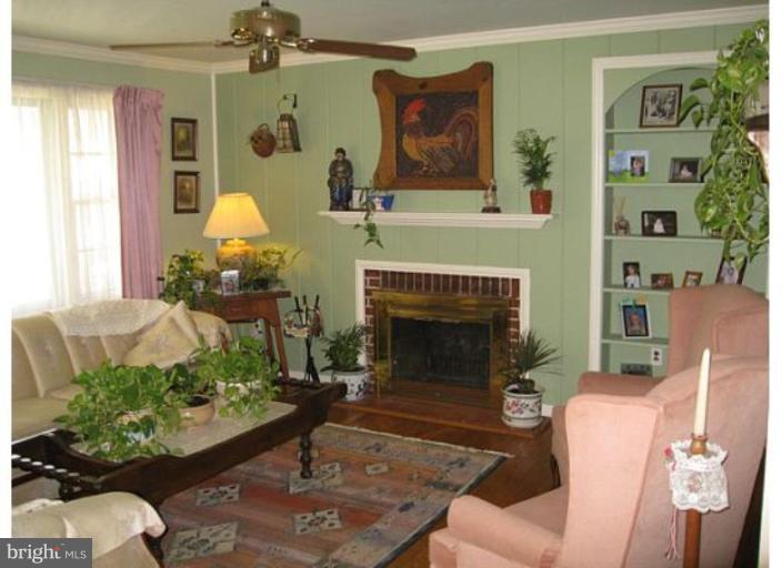 9117 Smith Avenue Nottingham, MD 21236 - Photo 10 of 17 a living room with furniture fireplace and a window