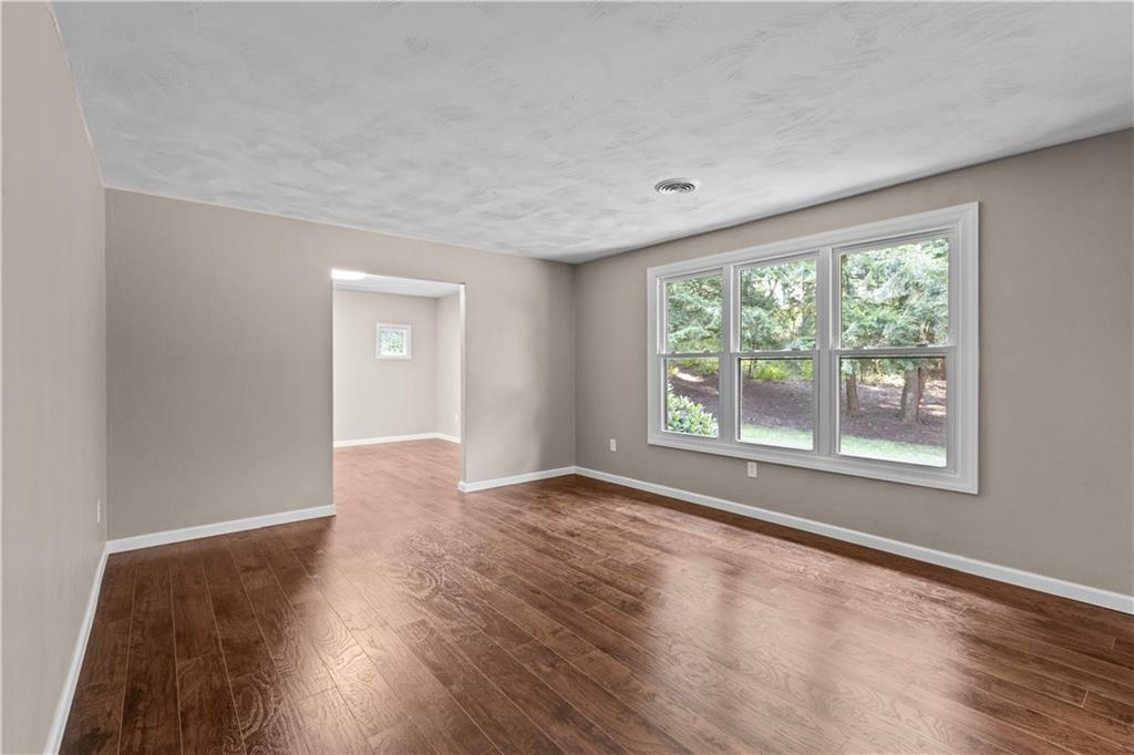 111 West Cruikshank Road Butler, PA 16002 - Photo 8 of 47 a view of an empty room with wooden floor and a window