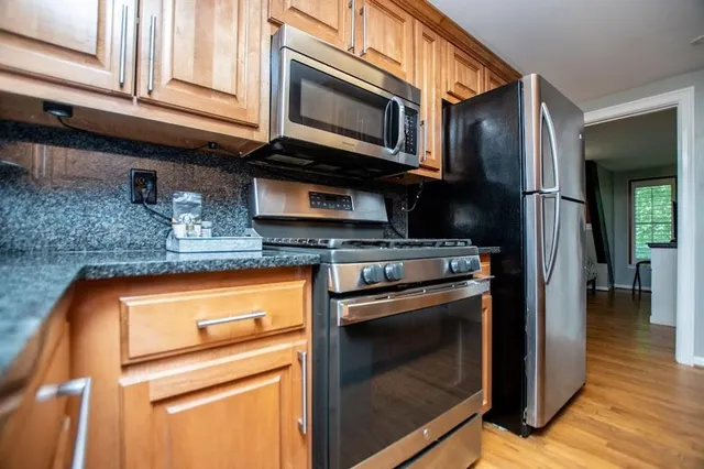 a bedroom with a bed and a night stand