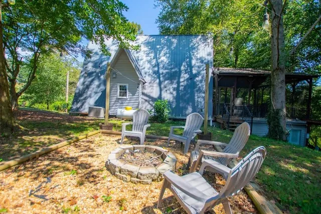 a view of house with backyard and outdoor seating