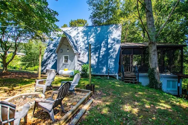 a view of a house with backyard porch and sitting area