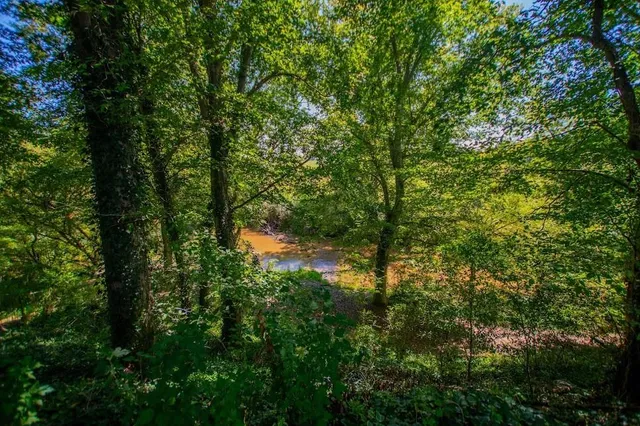 a kitchen with stainless steel appliances granite countertop a stove and a refrigerator
