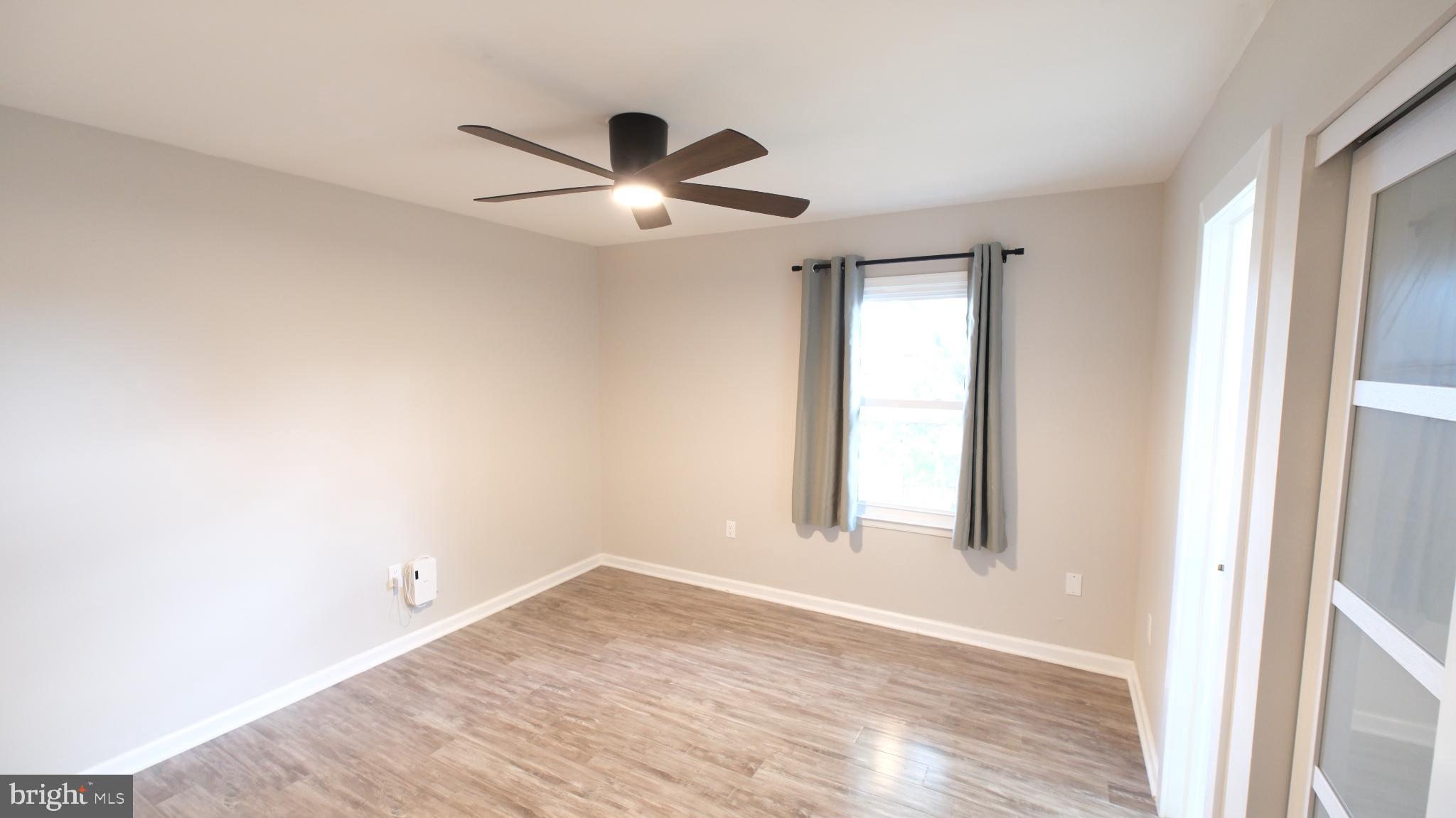 124 East Park Avenue Ranson, WV 25438 - Photo 16 of 23 wooden floor in an empty room with a window