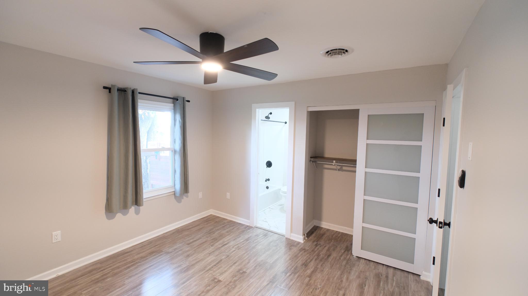 124 East Park Avenue Ranson, WV 25438 - Photo 17 of 23 a view of an empty room with wooden floor and a window