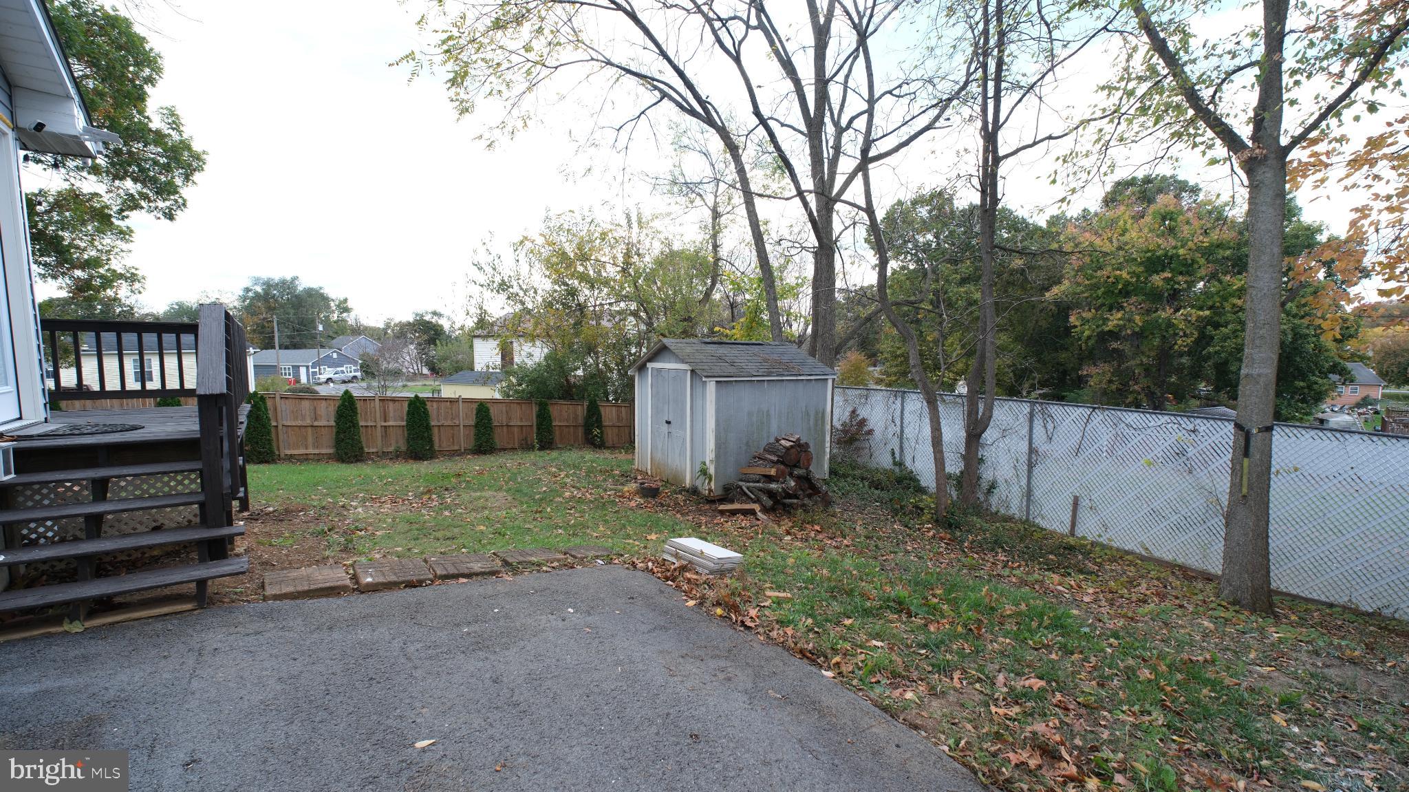 124 East Park Avenue Ranson, WV 25438 - Photo 2 of 23 a backyard of a house with barbeque oven and wooden fence