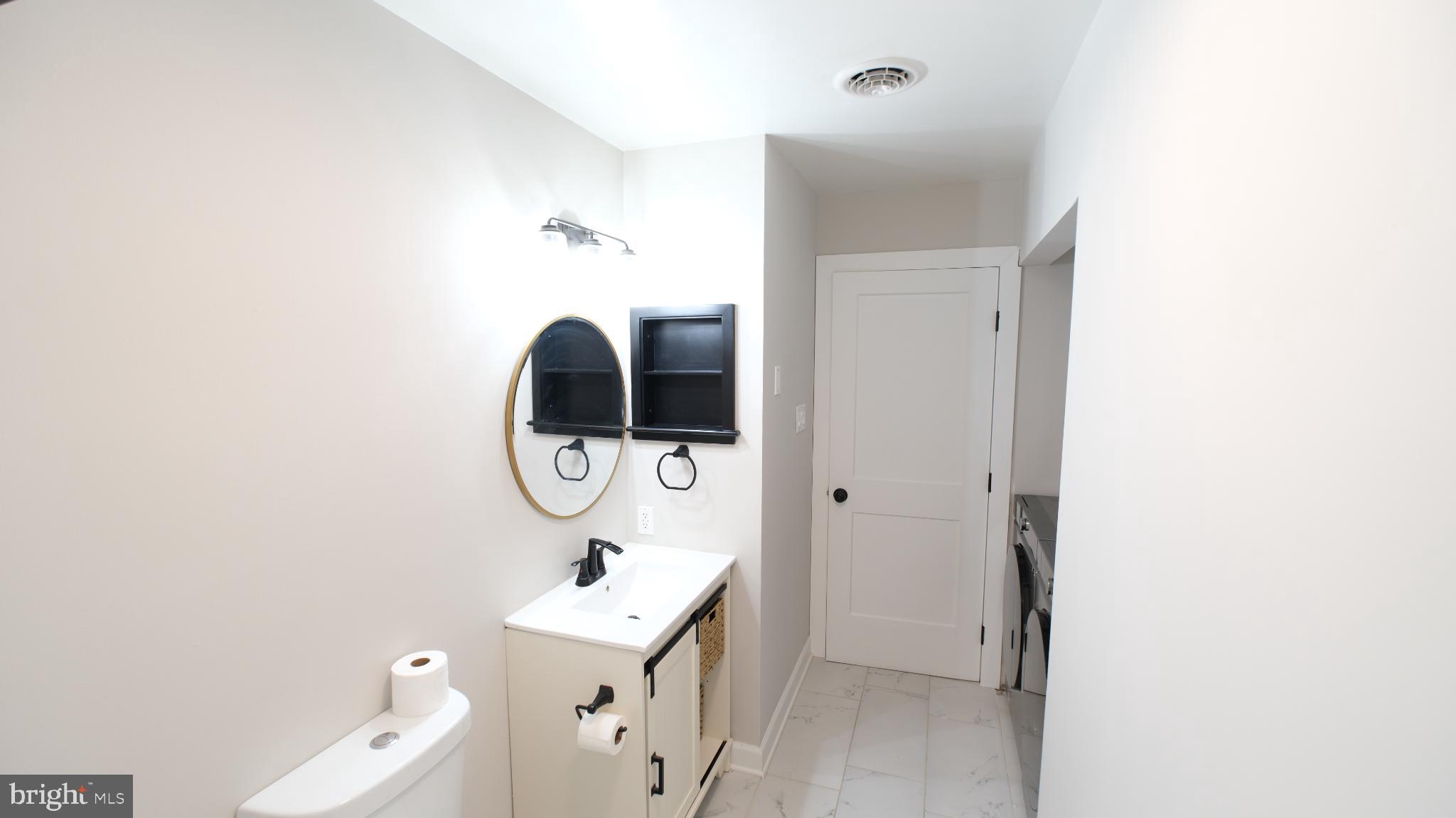 124 East Park Avenue Ranson, WV 25438 - Photo 22 of 23 a bathroom with a sink a mirror and a shower