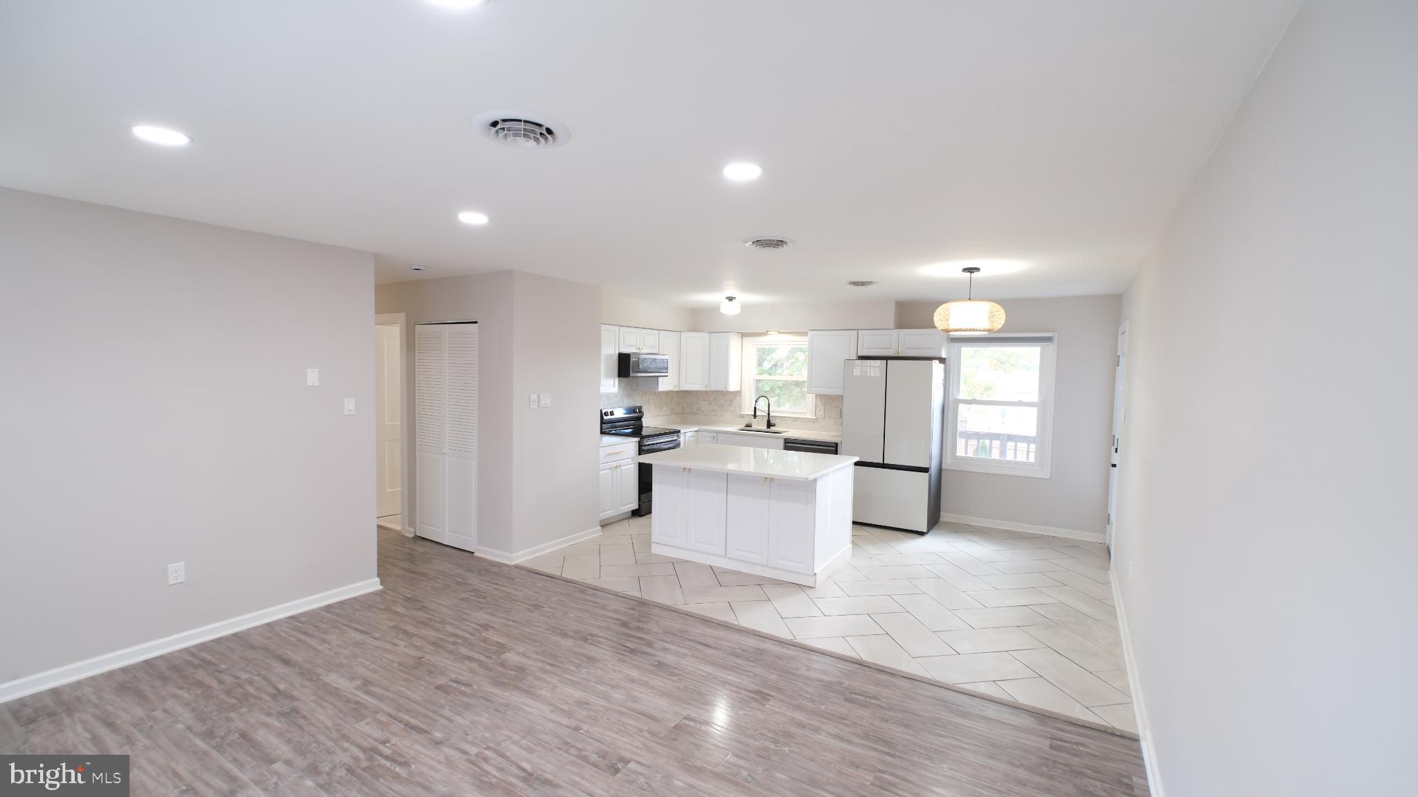 124 East Park Avenue Ranson, WV 25438 - Photo 7 of 23 a view of kitchen with kitchen island a sink white cabinets and stainless steel appliances