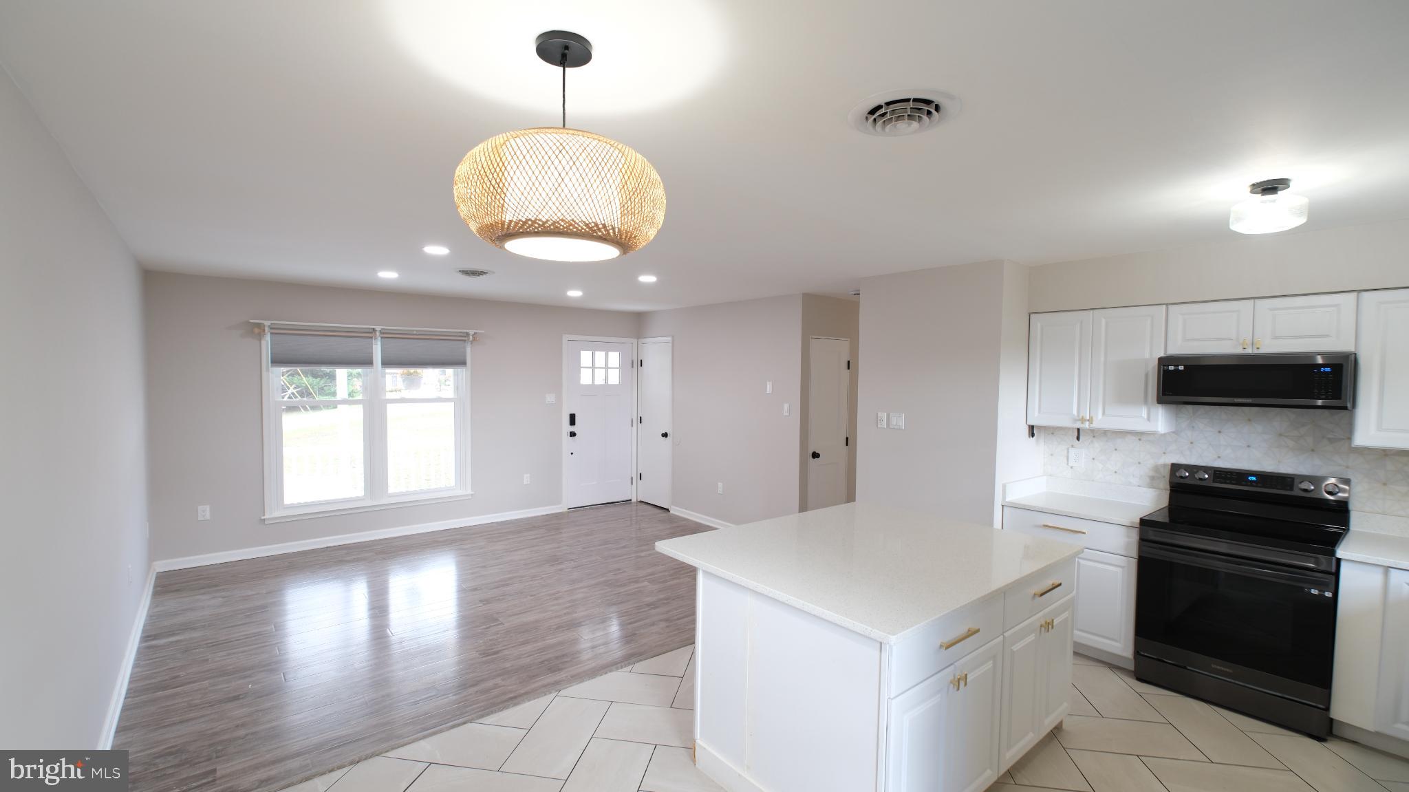 124 East Park Avenue Ranson, WV 25438 - Photo 8 of 23 a kitchen with a stove and a chandelier