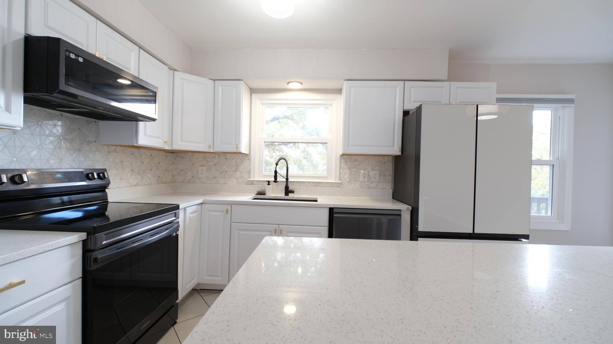 124 East Park Avenue Ranson, WV 25438 - Photo 10 of 23 a kitchen with stainless steel appliances a stove sink microwave and cabinets