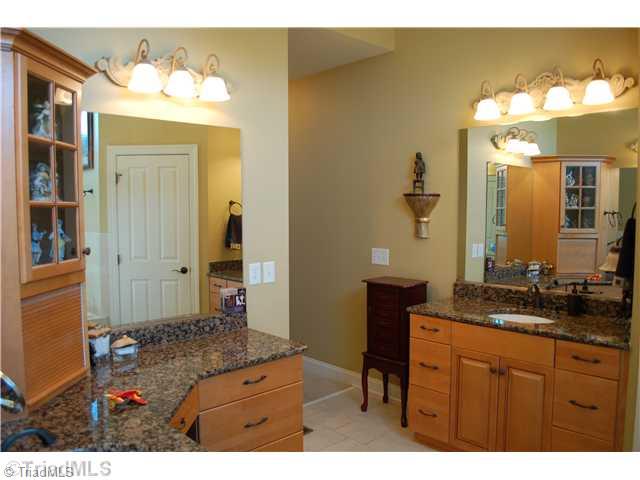 5624 Cape Fox Drive Oak Ridge, NC 27310 - Photo 11 of 16 Master Bath/Spa. Note custom cabinetry that allows you to store hairdryers & such.