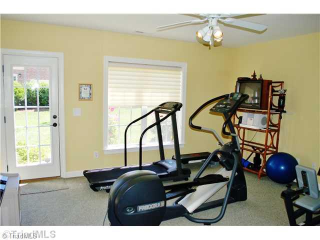 5624 Cape Fox Drive Oak Ridge, NC 27310 - Photo 13 of 16 Exercise. Lower level gym with outside entry & full bath could also serve as a guest suite.