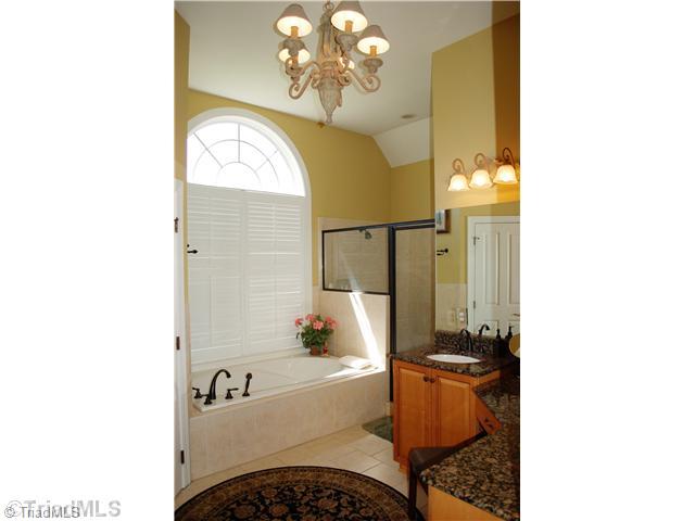 5624 Cape Fox Drive Oak Ridge, NC 27310 - Photo 10 of 16 Master Bath/Spa. This is the ultimate master bath: his & her vanities with granite counter tops, makeup vanity area, huge walk-in closet, cathedral ceiling over whirlpool tub, over sized tiled shower with dual heads, & private water closet.