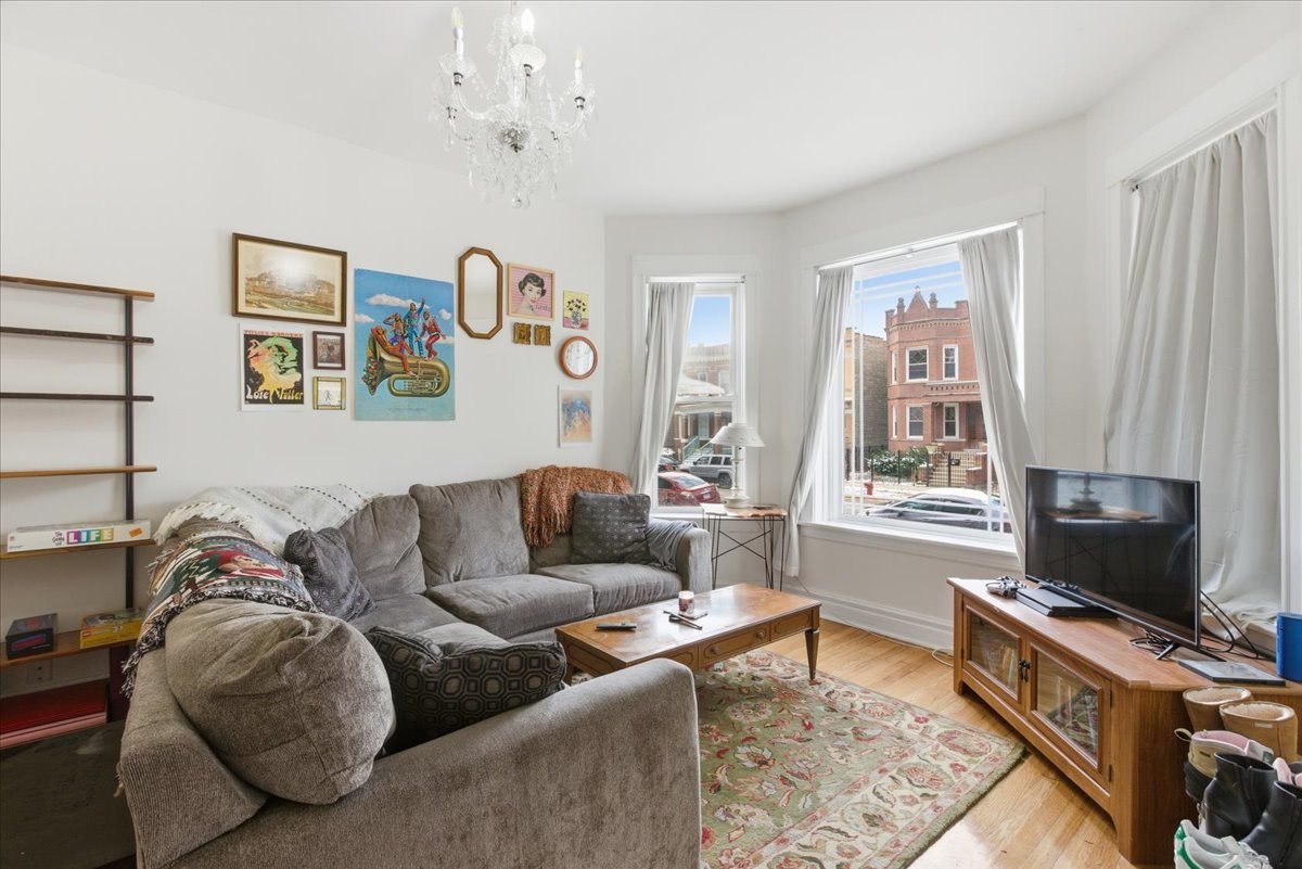 2333 North Hamlin Avenue, Unit 1 Chicago, IL 60647 - Photo 2 of 13 a living room with furniture and a flat screen tv