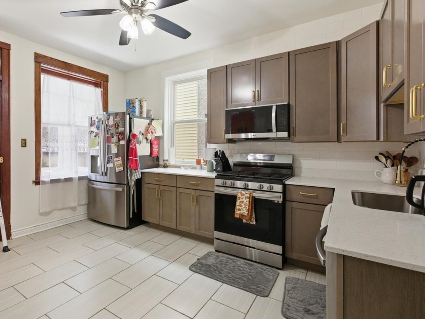 2333 North Hamlin Avenue, Unit 1 Chicago, IL 60647 - Photo 5 of 13 a kitchen with a sink cabinets and stainless steel appliances
