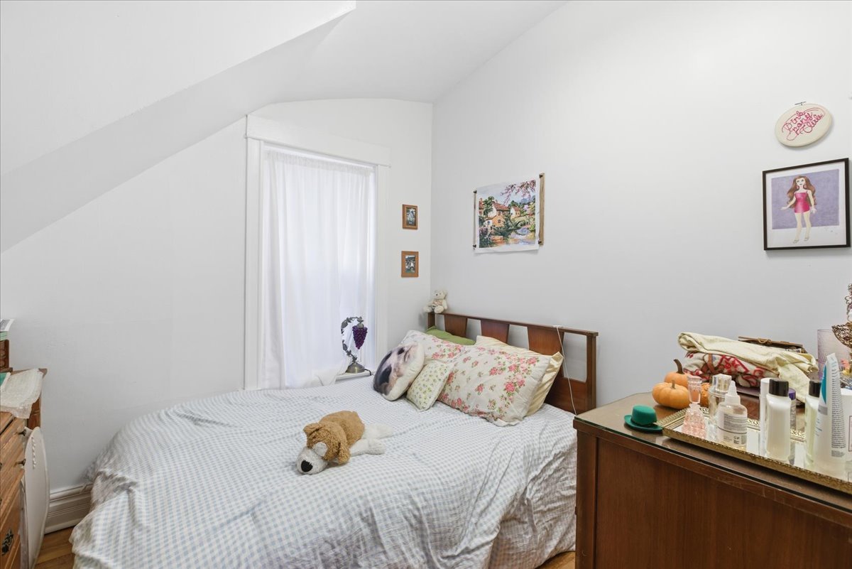 2333 North Hamlin Avenue, Unit 1 Chicago, IL 60647 - Photo 8 of 13 a bedroom with a bed and a dresser