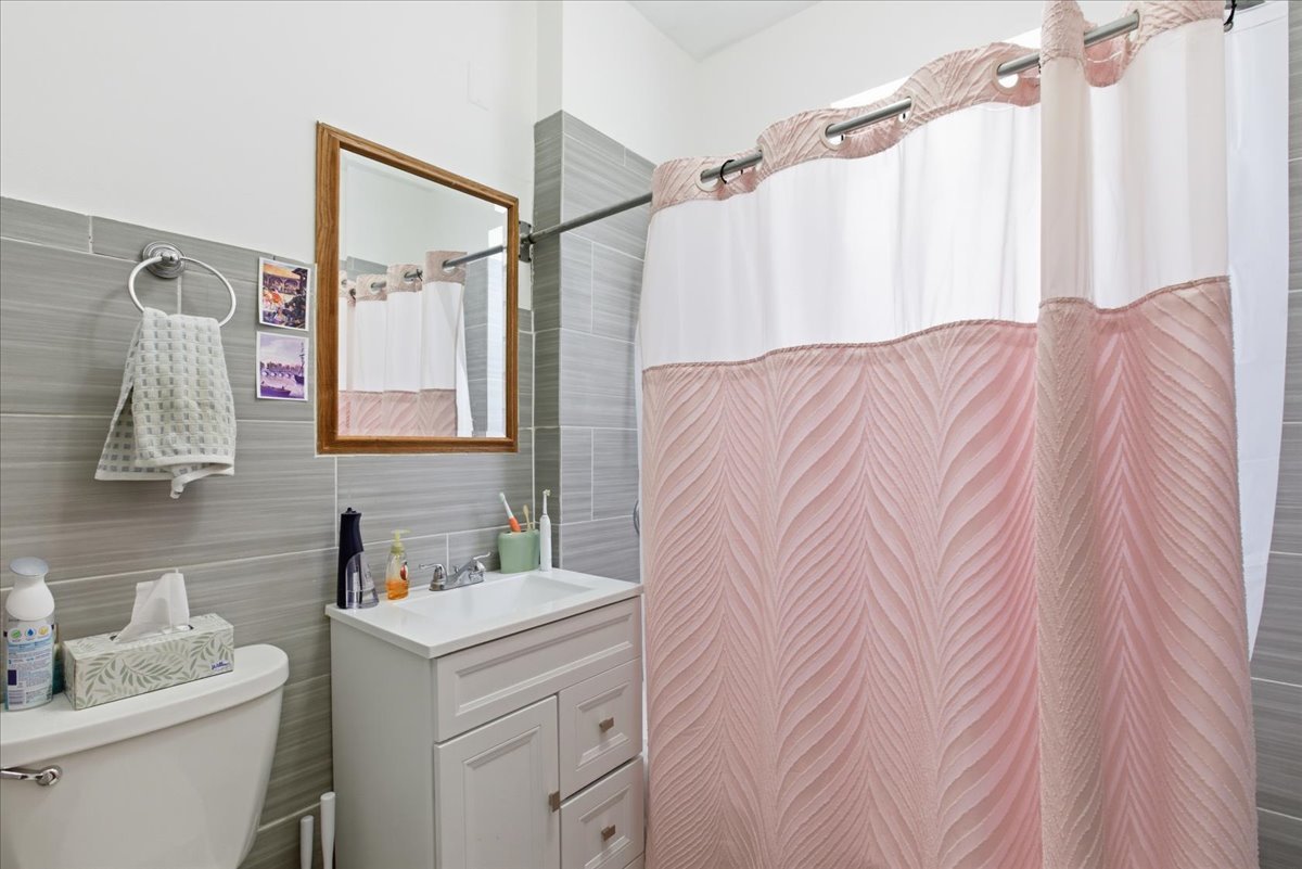 2333 North Hamlin Avenue, Unit 1 Chicago, IL 60647 - Photo 9 of 13 a bathroom with a sink vanity granite and a mirror