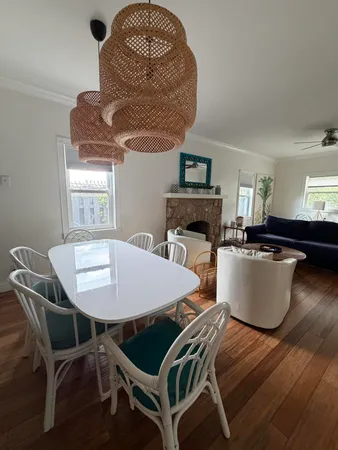 a living room with a table chairs and a dining table