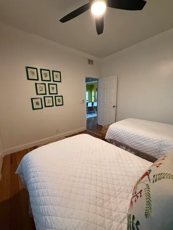 a bedroom with a bed and a painting on the wall