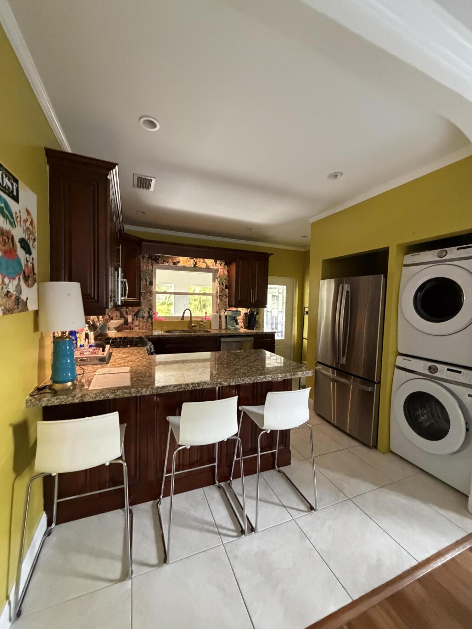 515 Ardmore Road West Palm Beach, FL 33401 - Photo 23 of 36 a kitchen with a table and chairs in it