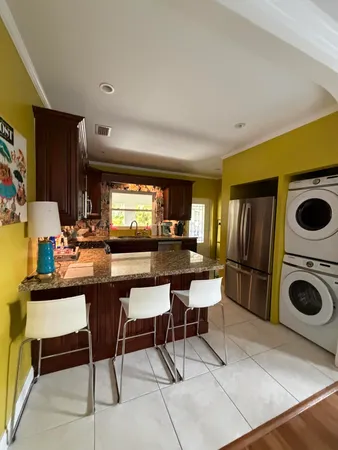 a kitchen with a table and chairs in it