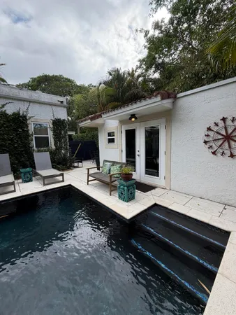 a view of a patio with swimming pool table and chairs