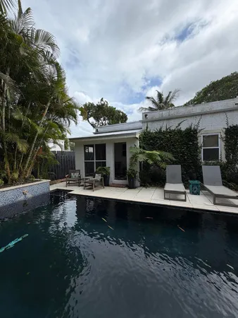 a view of house with backyard outdoor seating and green space