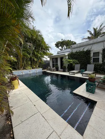 a view of swimming pool with outdoor seating and plants