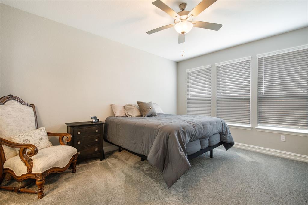 4113 Crossroads Court Oak Point, TX 75068 - Photo 12 of 33 a spacious bedroom with a bed and window