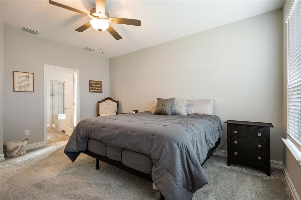 4113 Crossroads Court Oak Point, TX 75068 - Photo 13 of 33 a bedroom with a bed and a chandelier