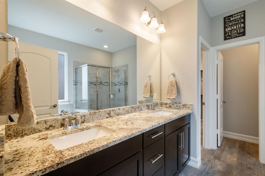 4113 Crossroads Court Oak Point, TX 75068 - Photo 15 of 33 a bathroom with a granite countertop double vanity sink and a mirror