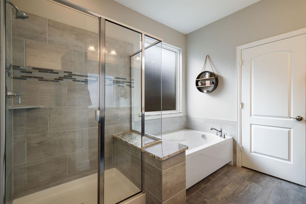 4113 Crossroads Court Oak Point, TX 75068 - Photo 16 of 33 a bathroom with a tub and a shower