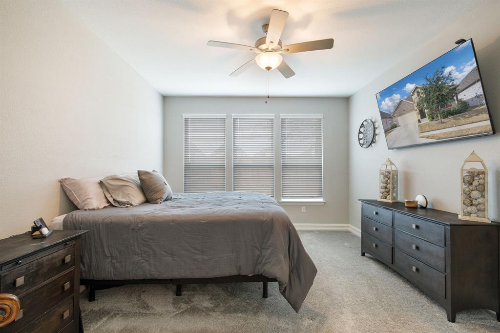 4113 Crossroads Court Oak Point, TX 75068 - Photo 17 of 33 a bedroom with a bed dresser and a window