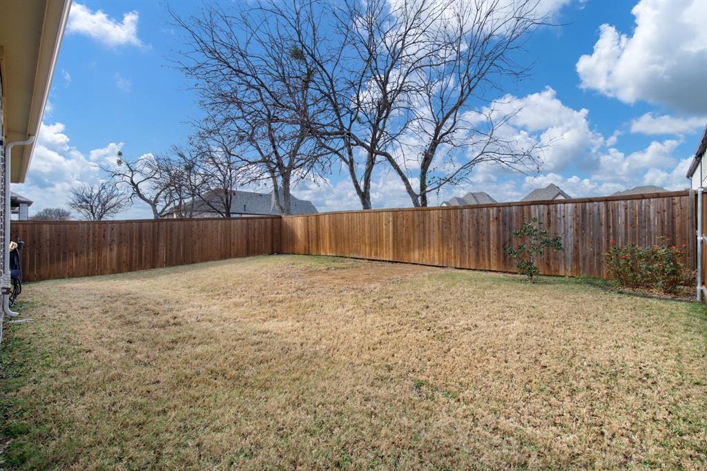 4113 Crossroads Court Oak Point, TX 75068 - Photo 26 of 33 a view of backyard with wooden fence