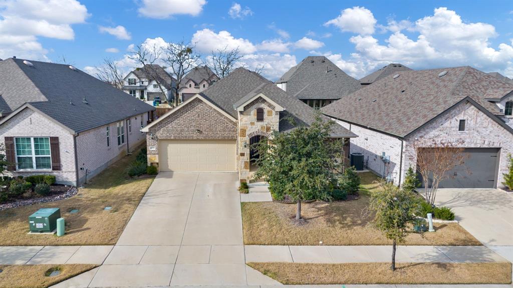 4113 Crossroads Court Oak Point, TX 75068 - Photo 3 of 33 a front view of a house with garden