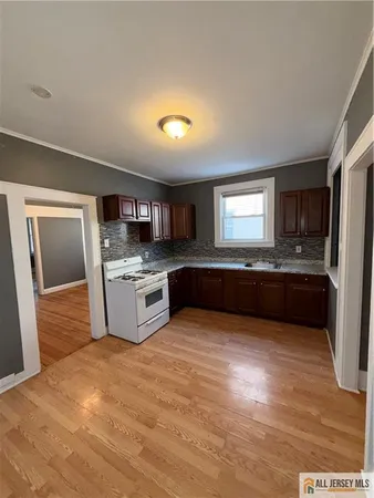 a large kitchen with stainless steel appliances granite countertop a large counter top and a stove