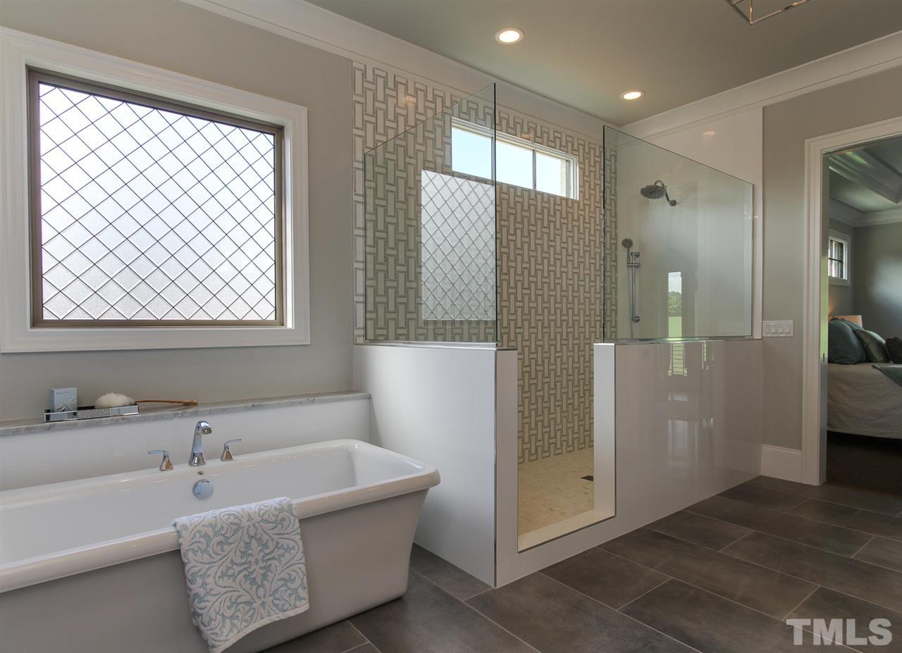 7910 Hardwick Drive Raleigh, NC 27615 - Photo 12 of 25 a bathroom with a tub and shower