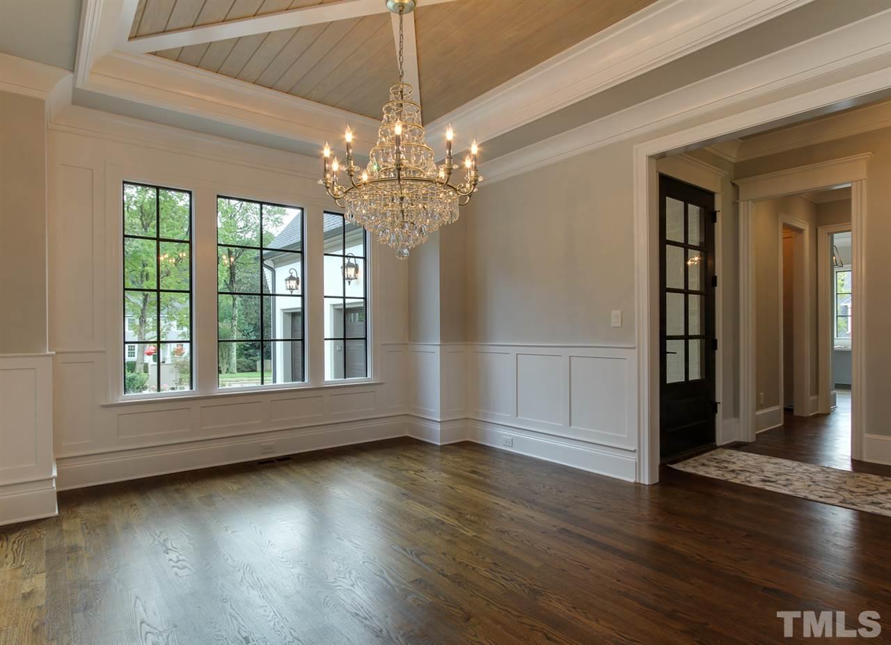 7910 Hardwick Drive Raleigh, NC 27615 - Photo 3 of 25 an empty room with wooden floor chandelier and windows