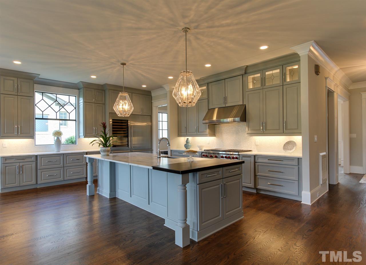7910 Hardwick Drive Raleigh, NC 27615 - Photo 5 of 25 a kitchen with granite countertop a stove and a wooden floors