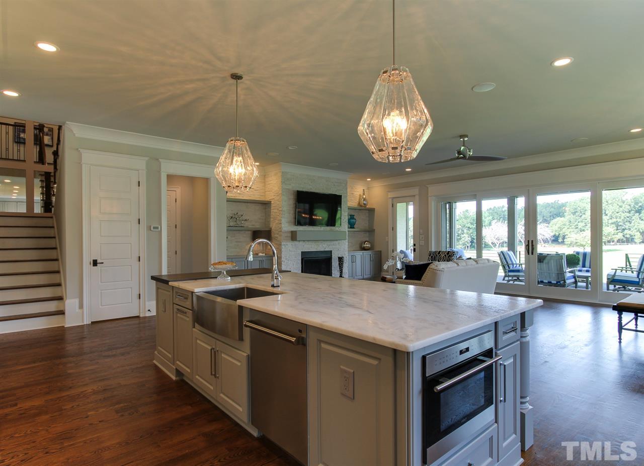 7910 Hardwick Drive Raleigh, NC 27615 - Photo 7 of 25 a kitchen with stove and center island