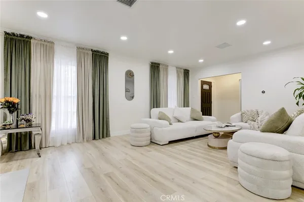 a living room with furniture and large mirror