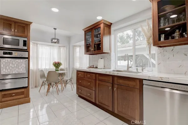 a spacious bathroom with a granite countertop sink and a mirror