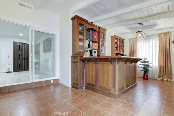 a view of a hallway with wooden floor and a bathroom