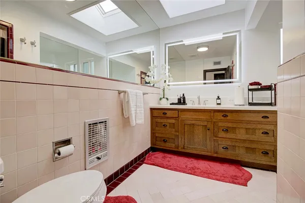 a bedroom with a bed and a large mirror