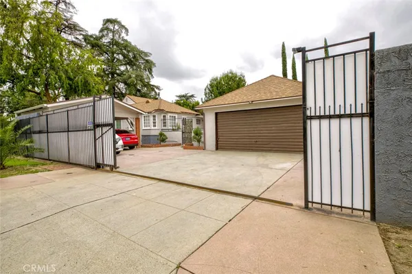 a view of a patio with a table and chairs under an umbrella