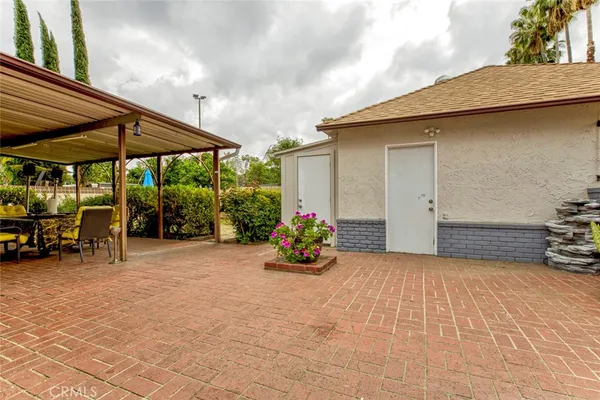 a swimming pool with outdoor seating and yard