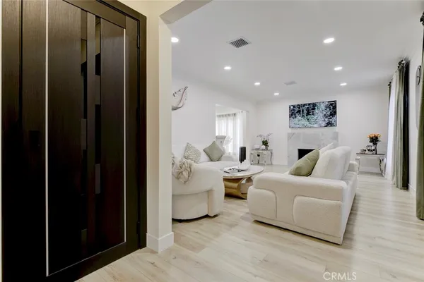 a living room with furniture and a painting on the wall
