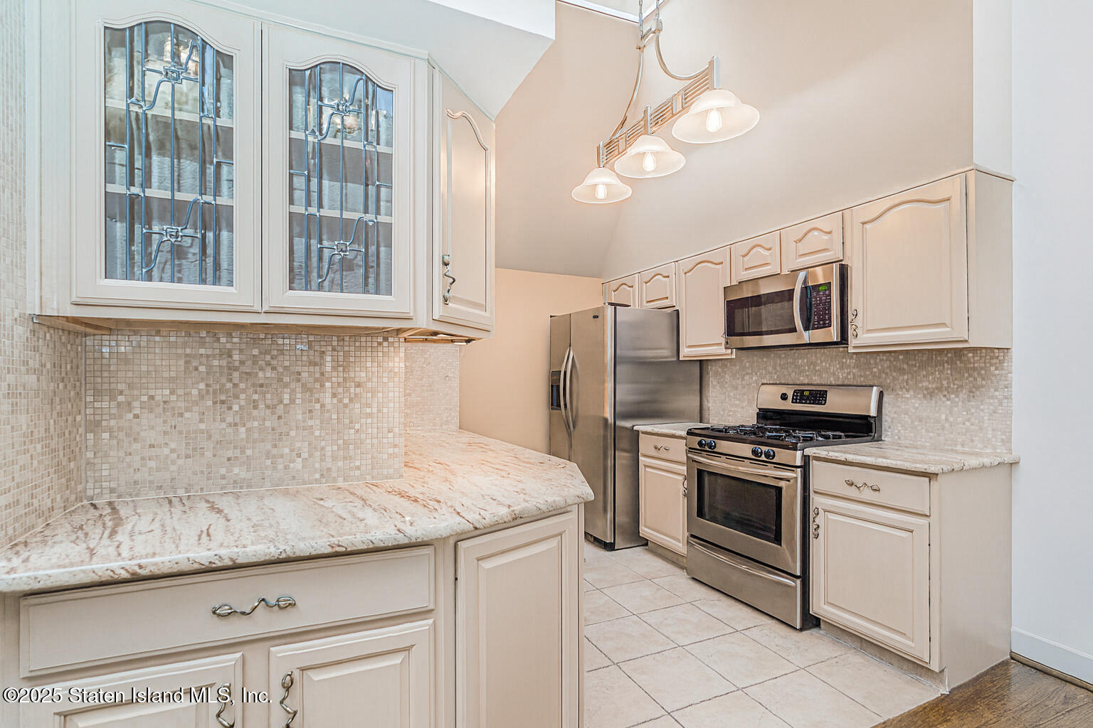 175 Winding Woods Loop, Unit 69 Staten Island, NY 10307 - Photo 12 of 29 a kitchen with stainless steel appliances granite countertop a stove and a microwave
